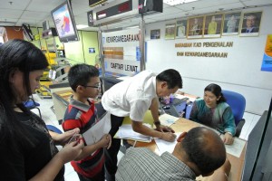 Photo shows SPCB Chief, Wilfred Yap at the National Registration Department assisting the couple from Batu Kawa with their application for citizenship for their child.